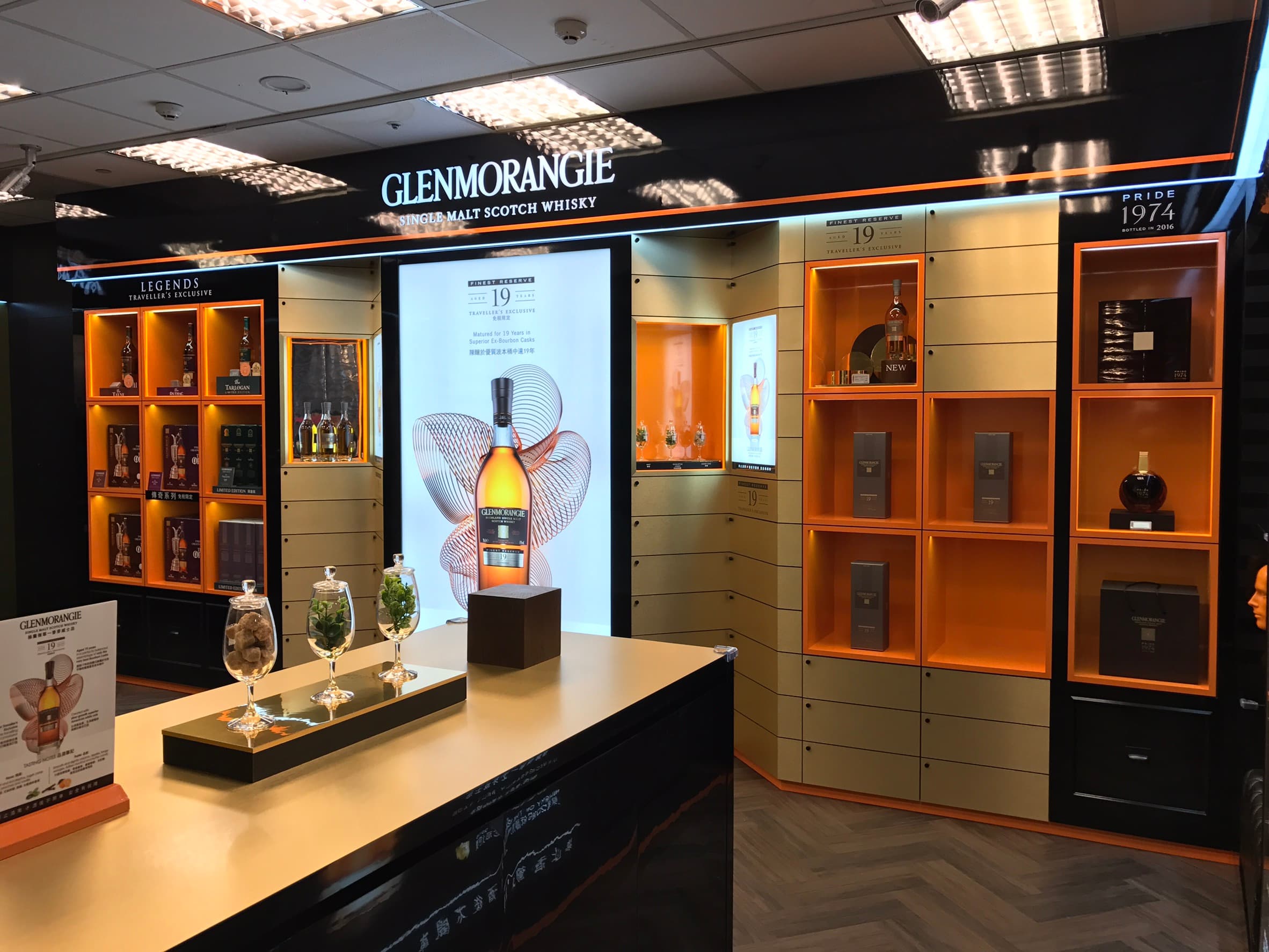 Whisky boutique display with orange shelving